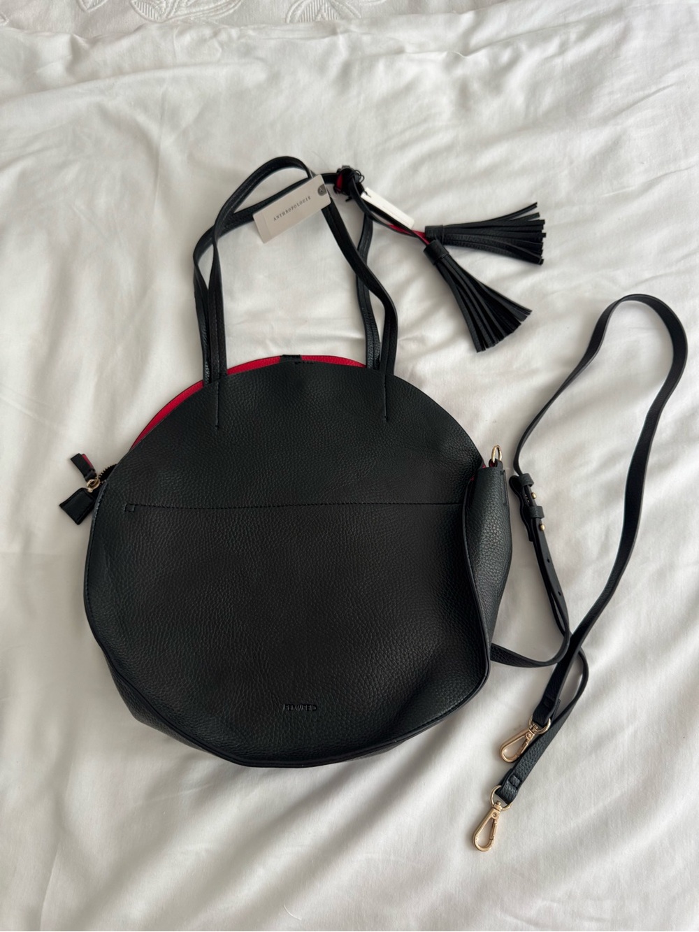 Anthropology Black Leather Round Tote with Red Accent and Tassel